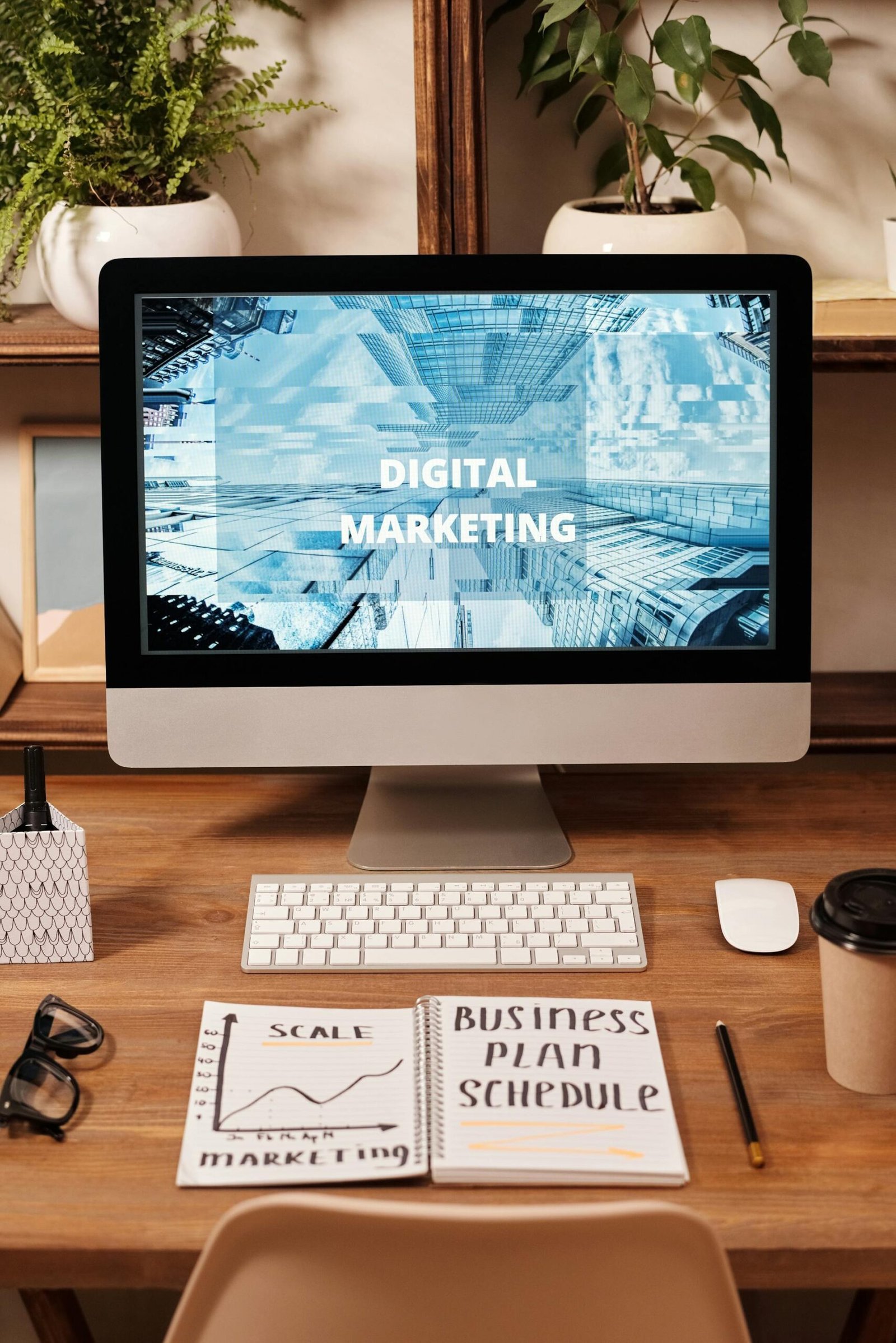 A computer screen displaying the wallpaper as digital marketing, with a book and pen in browntable.